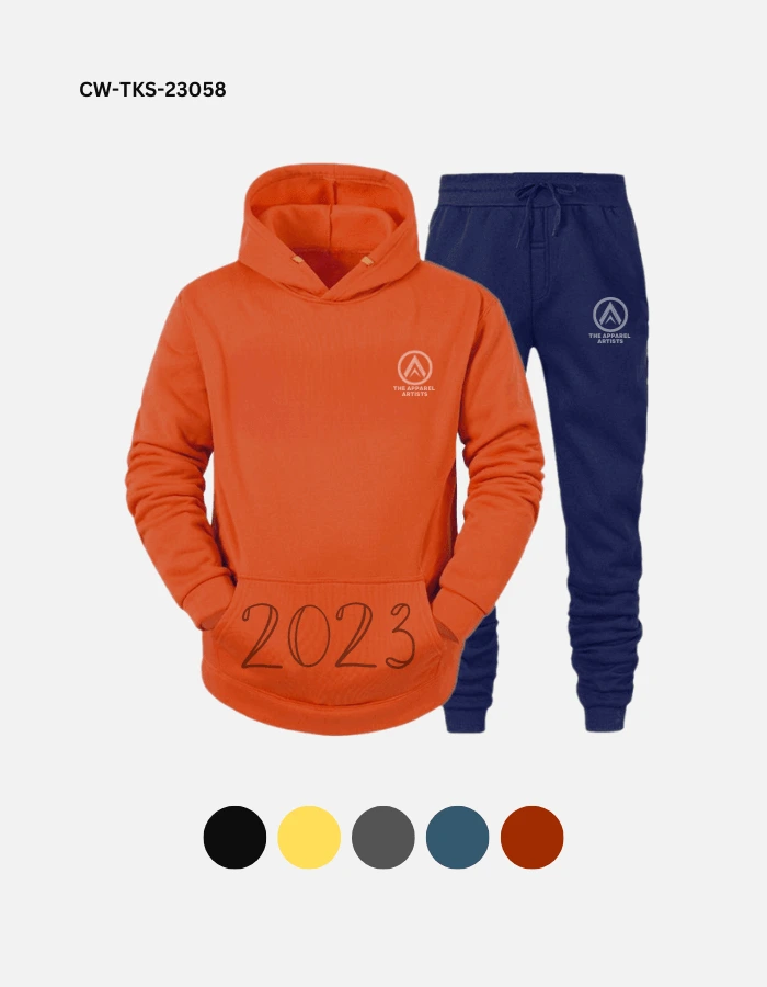 A fashion track suit in orange and blue color with "2023" written in embroidery on the kangaroo pocket.