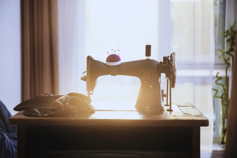 A close-up view of a precision sewing machine meticulously stitching a garment, symbolizing The Apparel Artist's dedication to craftsmanship and quality.