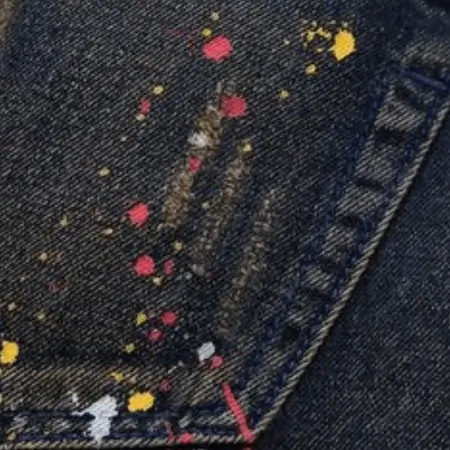 A close-up image of a garment featuring an authentic and stylish denim wash effect, professionally crafted by The Apparel Artist.