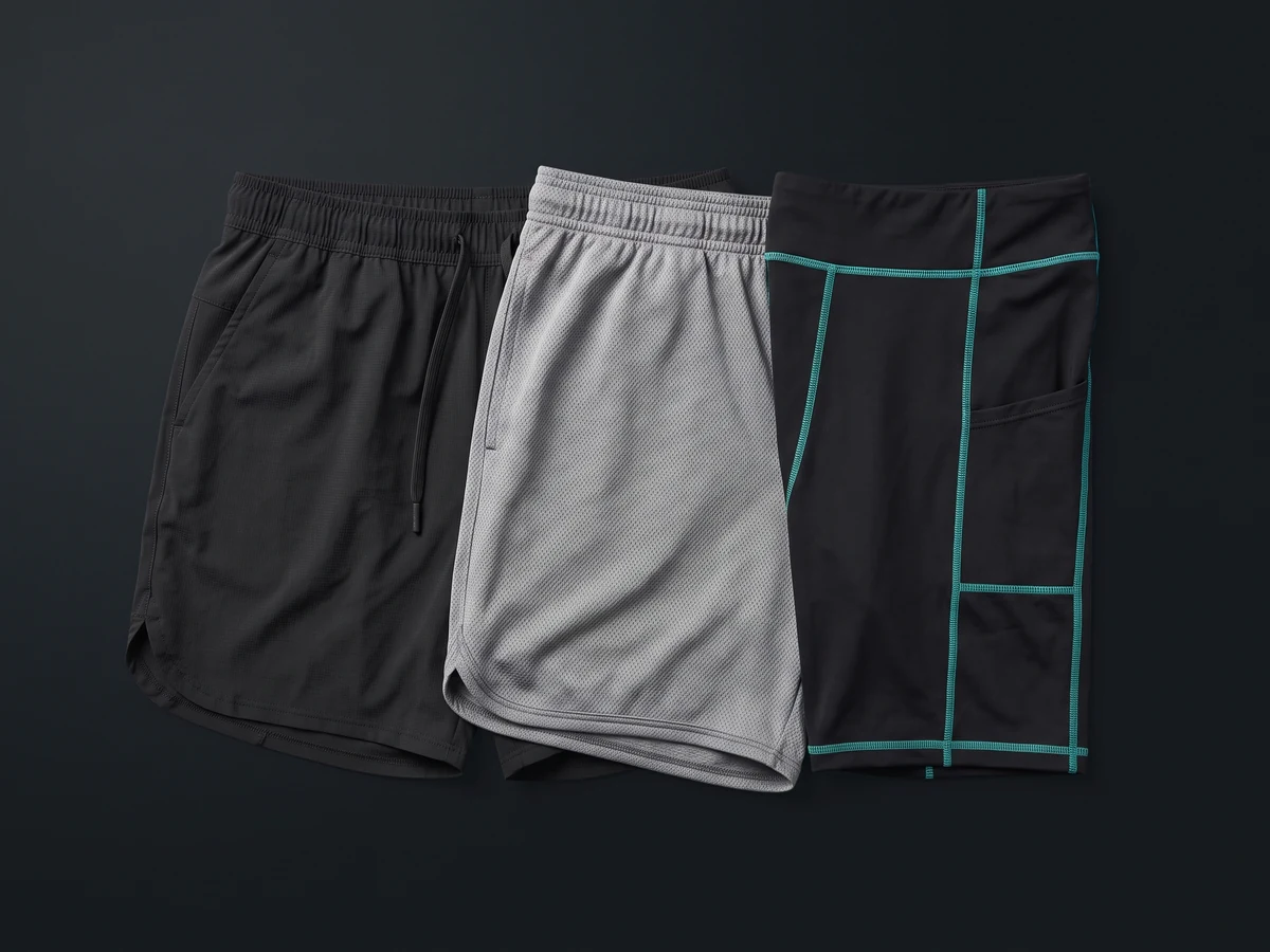 Three gym shorts styles — woven training, mesh and compression — laid out for private label sampling