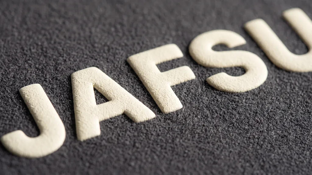 Close-up macro of raised puff print lettering standing off a heavyweight fleece hoodie