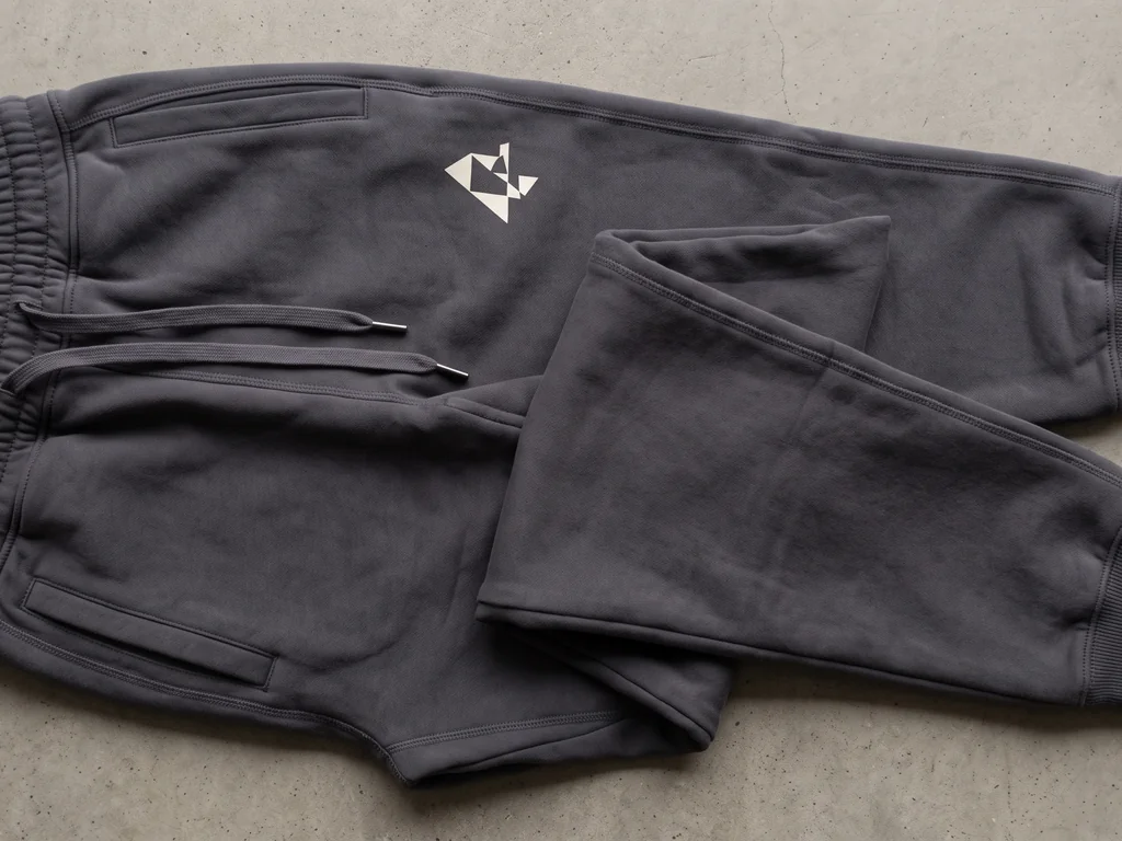 Tapered fleece joggers with a drawcord waist and a custom thigh print, folded flat
