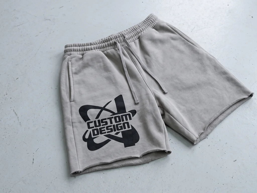 Heavyweight fleece shorts with a drawcord waist and a bold CUSTOM DESIGN print, folded flat